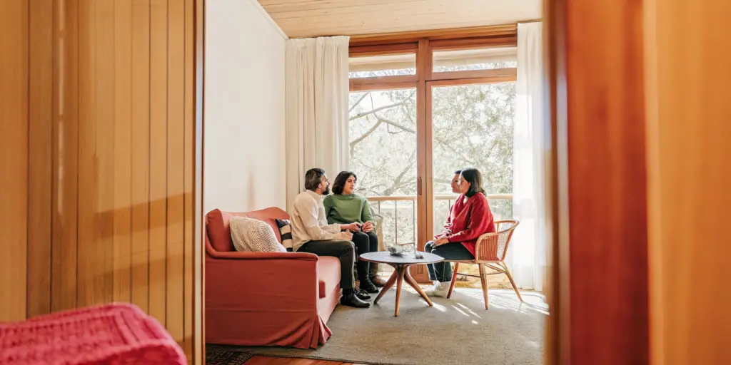 Family discussing family therapy for addiction with a counselor