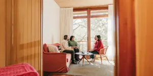 Family discussing family therapy for addiction with a counselor