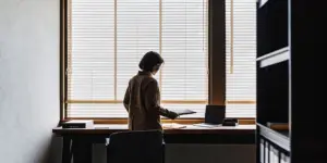 Professional preparing notes while learning how to tell your employer you are going to rehab