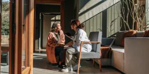 Physician speaking with a patient in a bright modern medical office